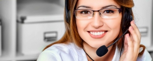 Friendly smiling young woman surrort phone operator at her workp